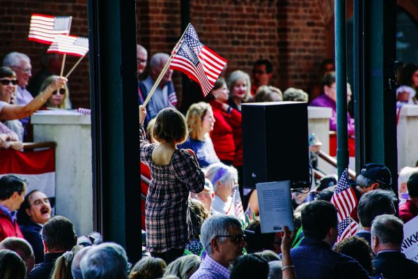 A young girl waves an American flag during Nikki Haley's campaign announcement on Wednesday, Feb. 15, 2023, at the Charleston Visitor Center.
