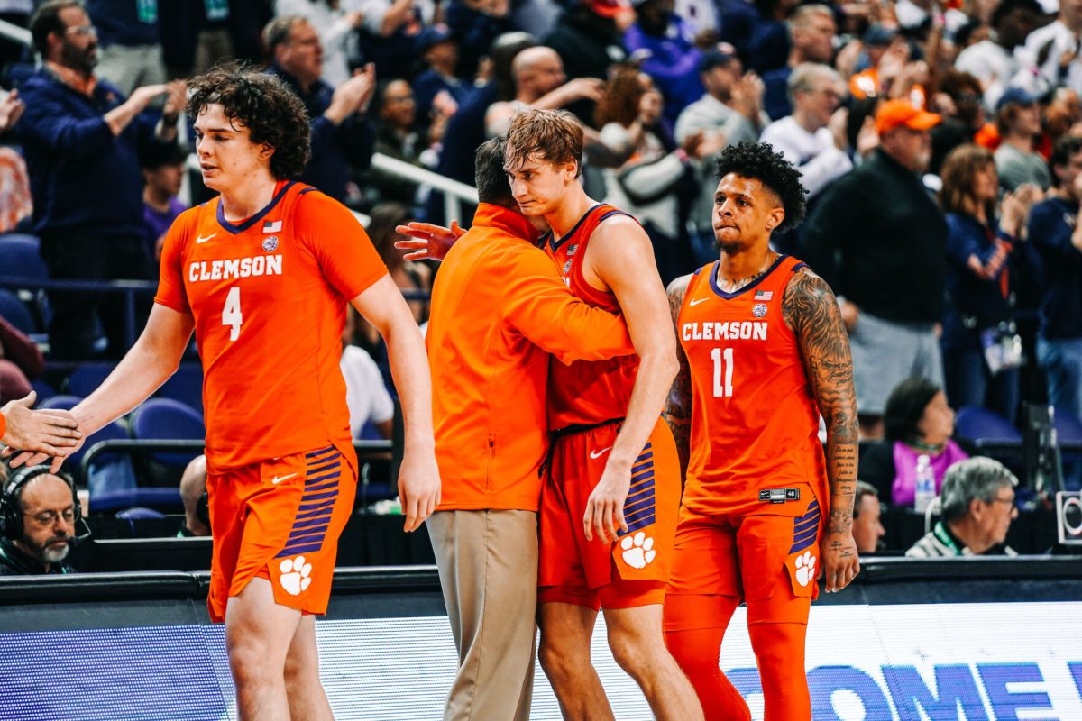 Clemson forward Ian Schieffelin (4), forward Hunter Tyson and guard Brevin Galloway (11) come off the court during the Tigers 76-56 loss to Virginia in the ACC Tournament semifinals in Greensboro, North Carolina.