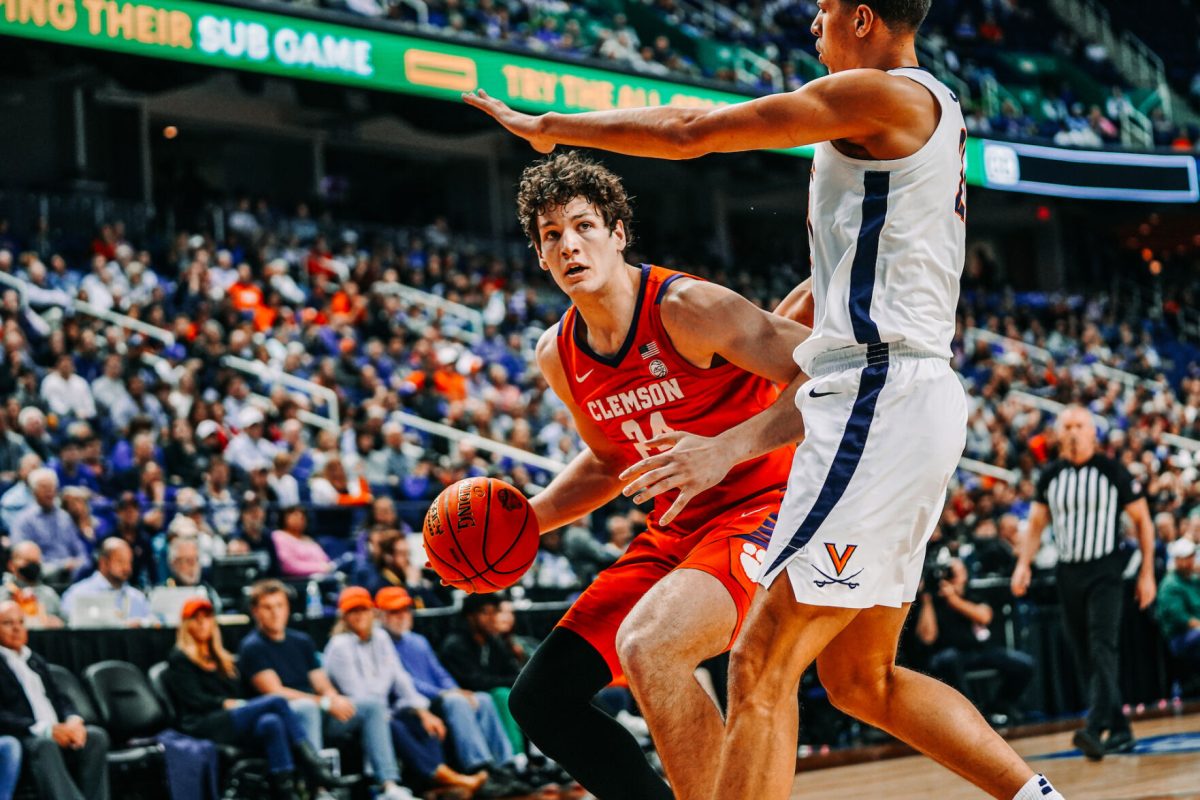 Clemson forward PJ Hall (24) posts up against Virginia in the semifinals of the 2023 ACC Tournament.