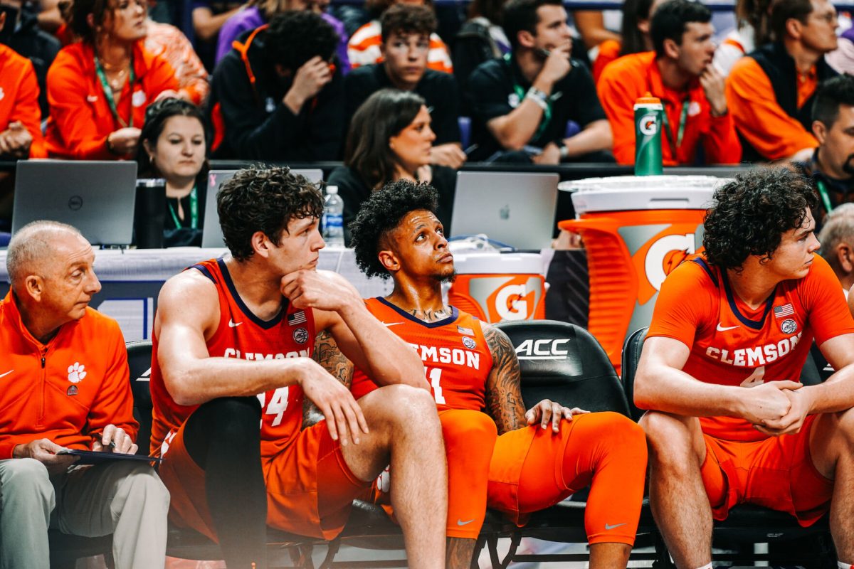 Clemson center PJ Hall (24), guard Brevin Galloway (11) and forward Ian Schieffelin (4) sit on the bench during the Tigers 76-56 loss to Virginia in the semifinals of the 2023 ACC Tournament.