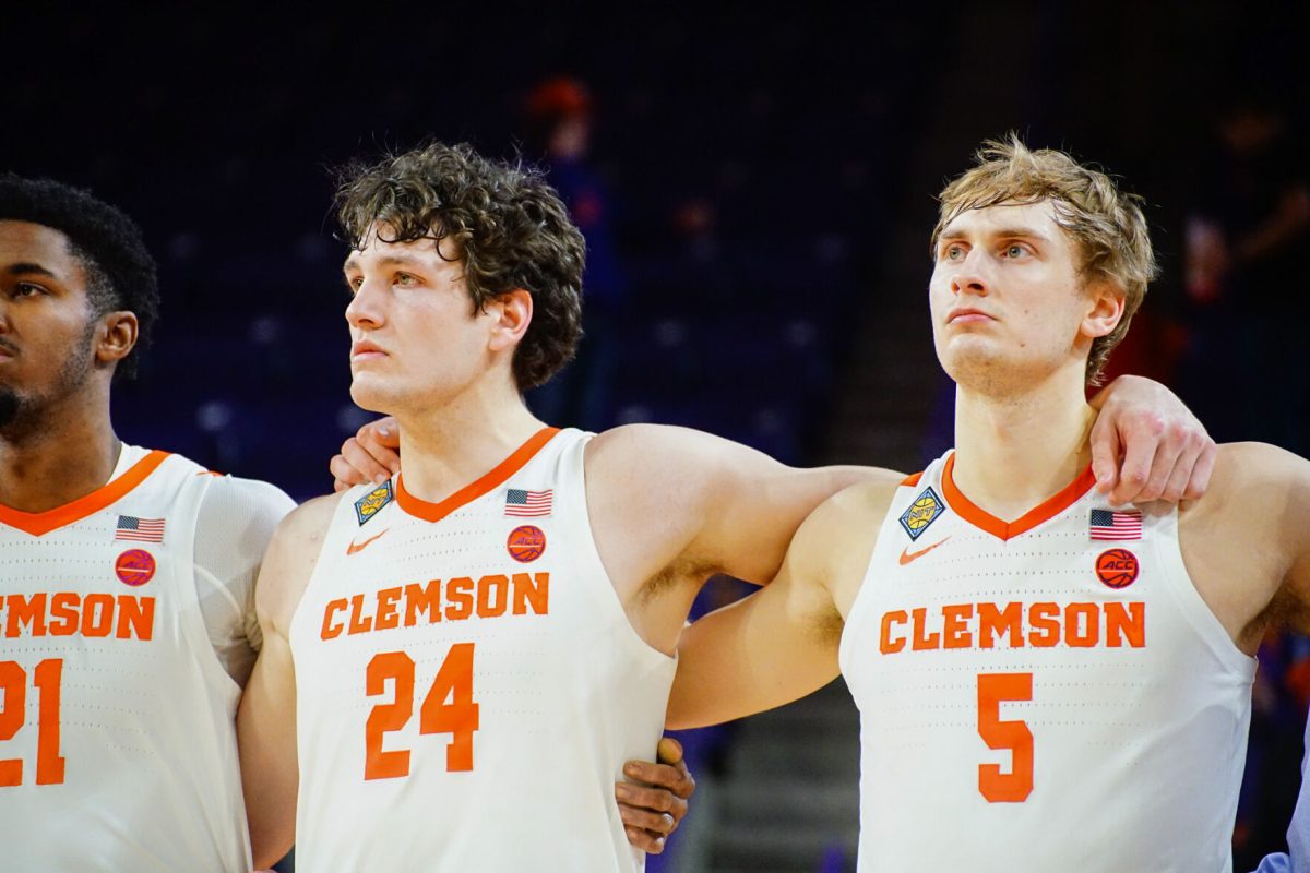 PJ Hall (24) and Hunter Tyson (5) standing for the alma mater after Clemsons first round NIT loss to Morehead State at Littlejohn Coliseum on March 15. 