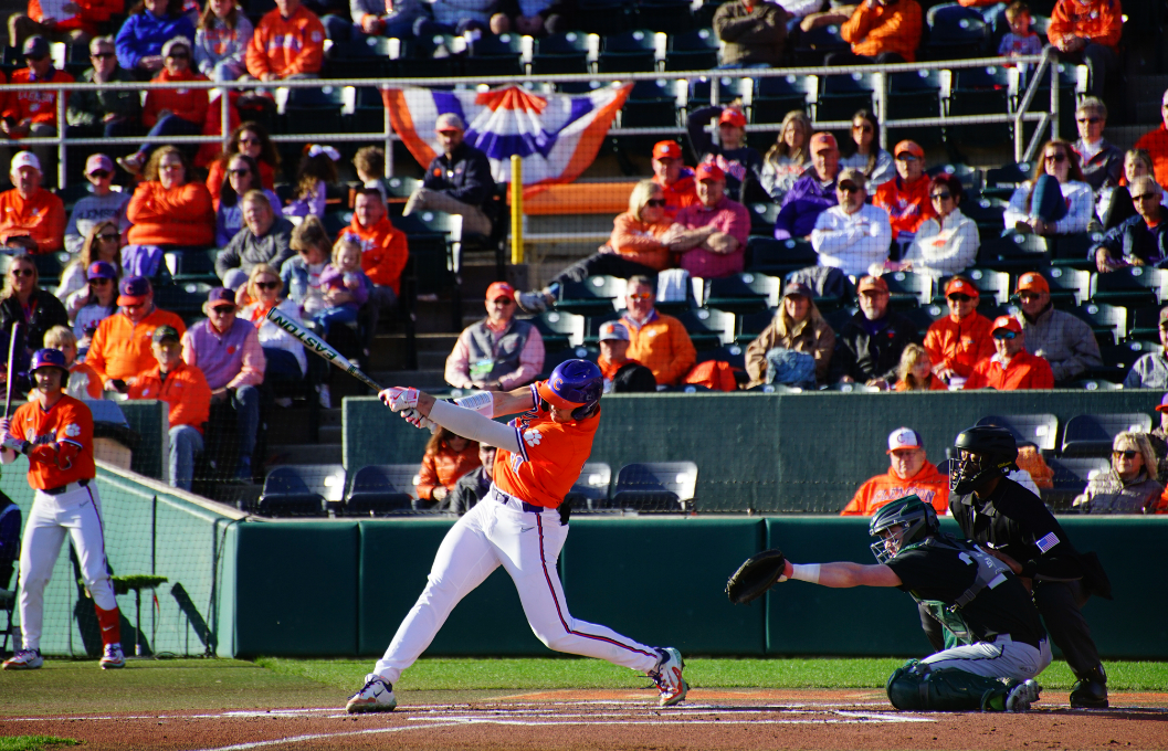 Clemson first baseman and pitcher Caden Grice sends the ball flying in Clemsons home opener victory over Binghamton on February 17.