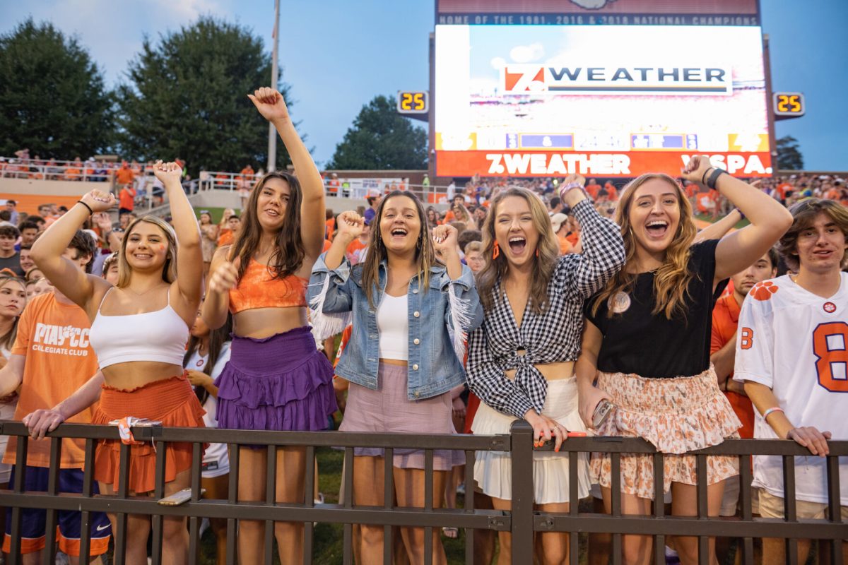 Clemson students in game day outfits cheer on the Clemson football team during a game against Boston College in 2021.