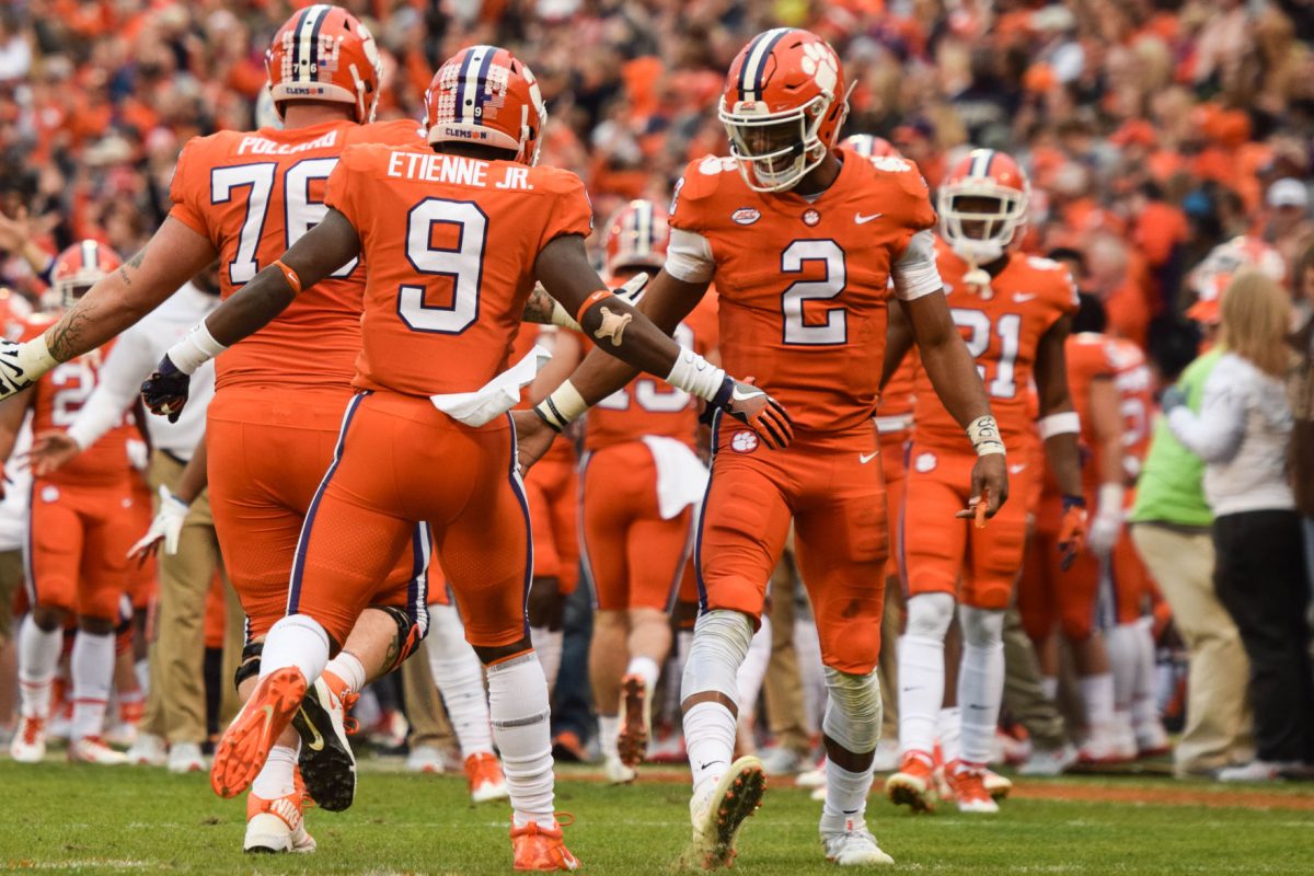 Kelly Bryant and Travis Etienne celebrate a touchdown.
