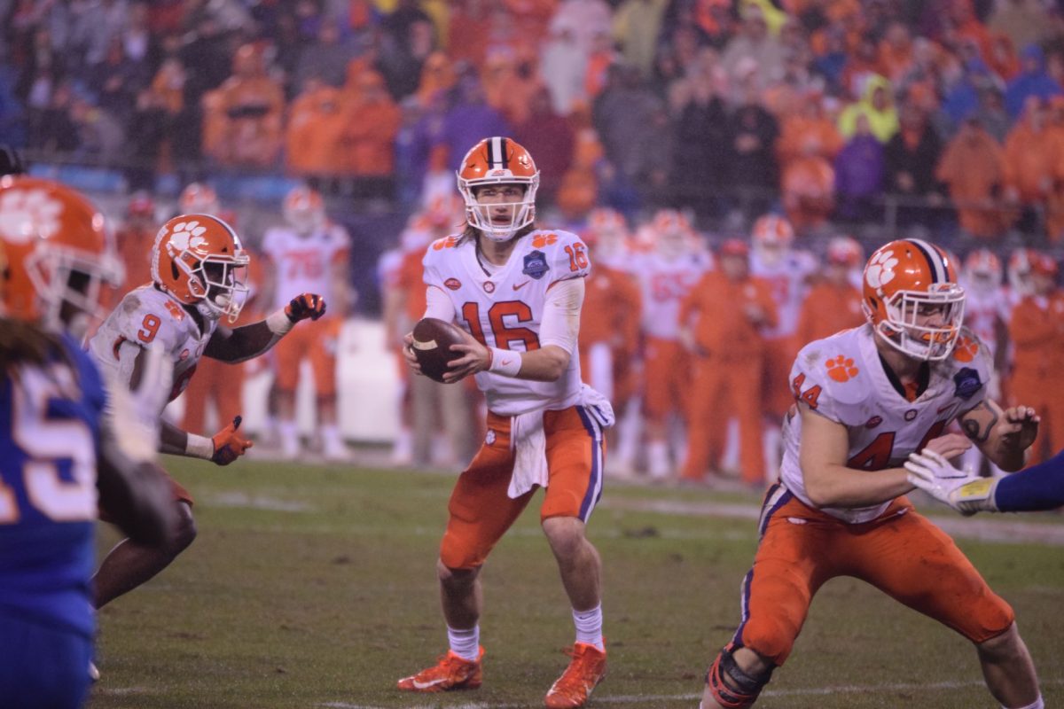 Trevor Lawrence (16) hands the ball off to Travis Etienne (9). Etienne had an outstanding game and finished with 156 rushing yards and two touchdowns and helped propel the Tigers to a 42-10 victory over the Pittsburgh Panthers.&#160;