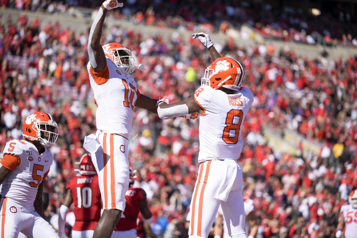 Clemson receivers Tee Higgins (5), Joseph Ngata (10), and Justyn Ross (8) celebrate a touchdown against Louisville.&#160;