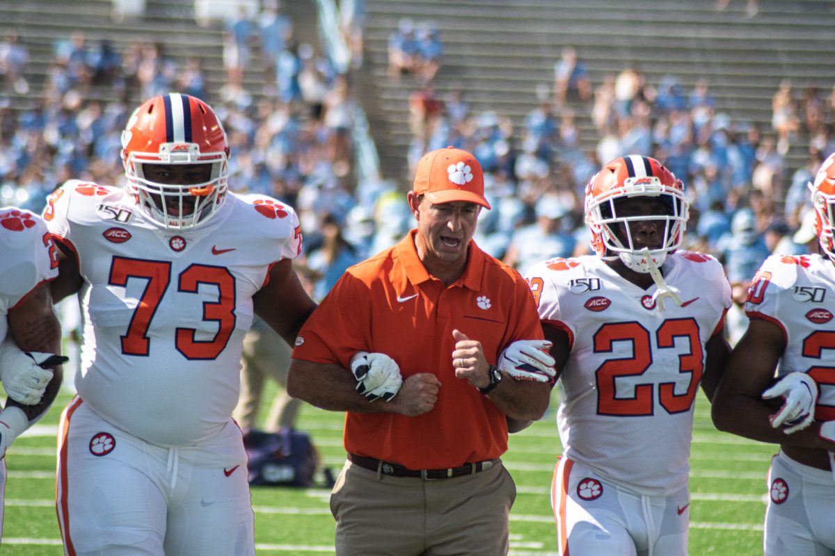 Tremayne Anchrum (73), Dabo Swinney, and Lyn-J Dixon (23) prepare for the game against North Carolina.&#160;