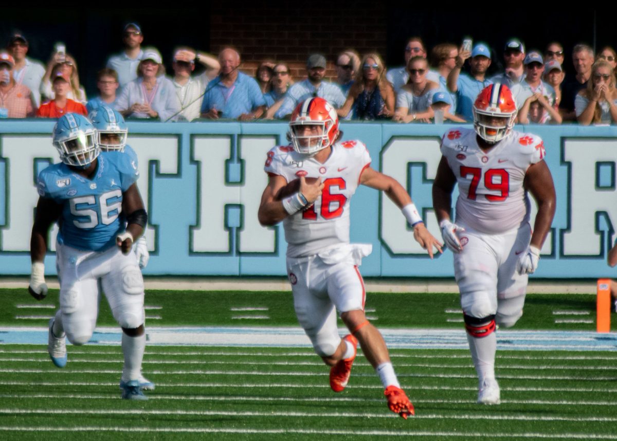 Clemson quarterback Trevor Lawrence rushes downfield against North Carolina.&#160;