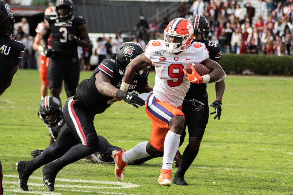 Running back Travis Etienne (9) sheds tacklers in Clemson's 38-3 win over South Carolina.&#160;&#160;