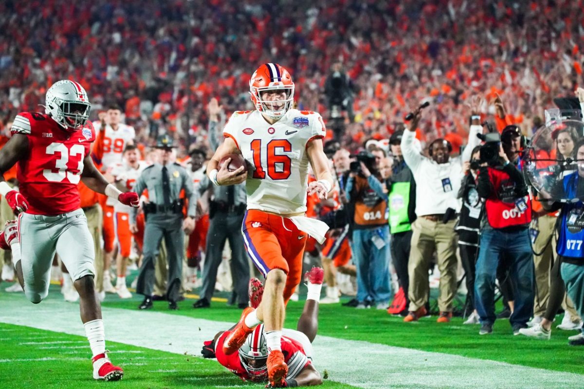 Clemson quarterback Trevor Lawrence (16) runs down the sideline for a touchdown in the Fiesta Bowl.&#160;