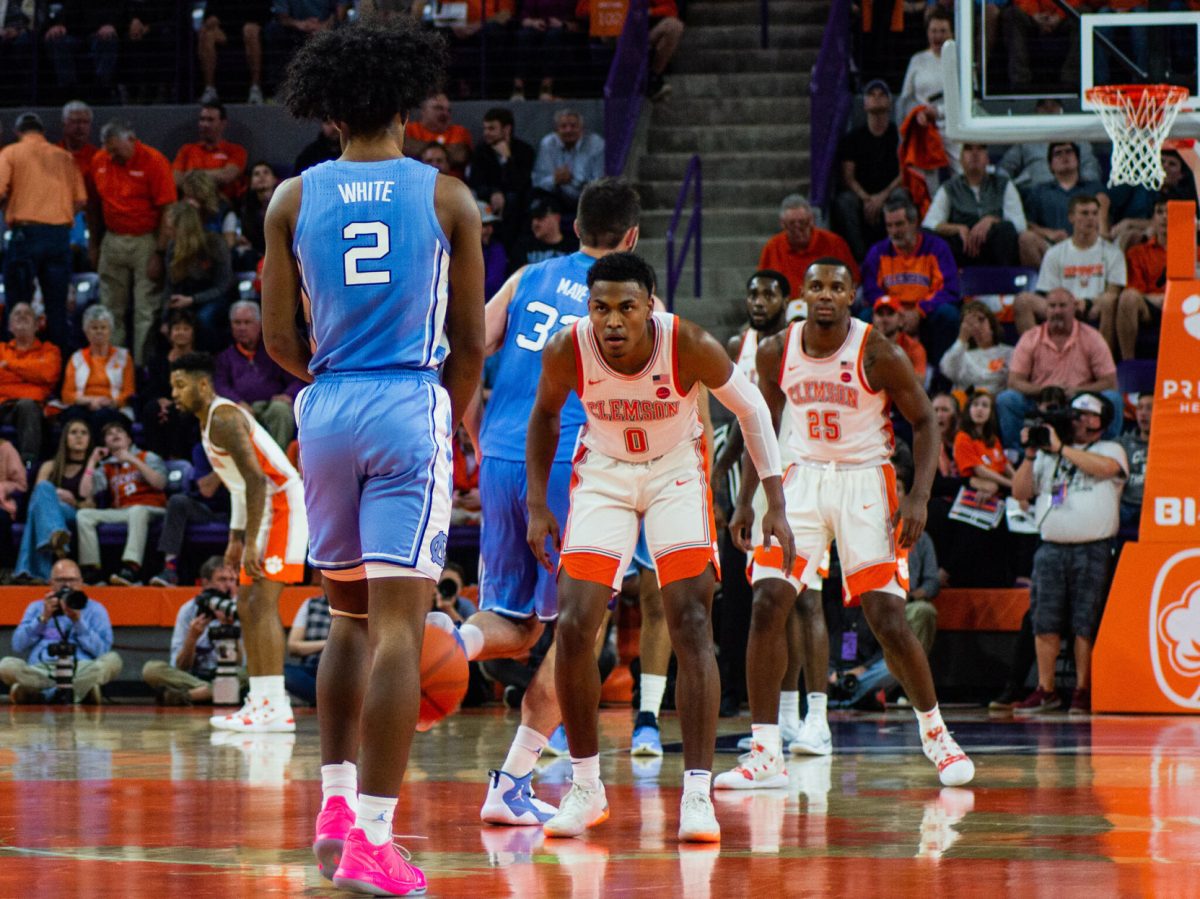 Now-junior Clemson guard Clyde Trapp (0) awaits former UNC standout Coby White (2) during last season's contest in Littlejohn Coliseum.