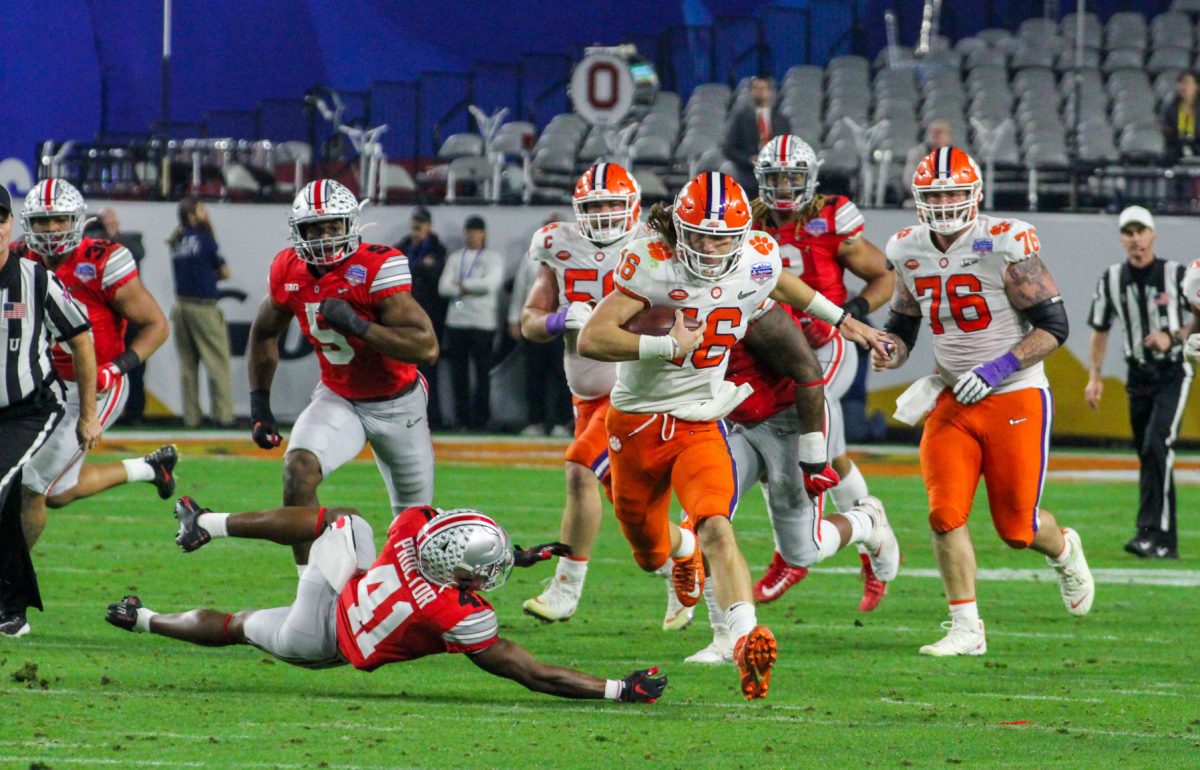 Clemson quarterback Trevor Lawrence (16) scrambles downfield against Ohio State in the Fiesta Bowl.