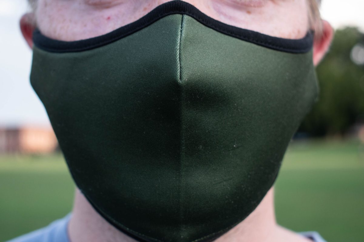 A Clemson student wears a mask on Bowman Field.