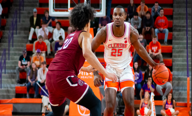 <p>Aamir Simms (25) evaluates his options as he takes the ball up the court against UofSC in 2019</p>