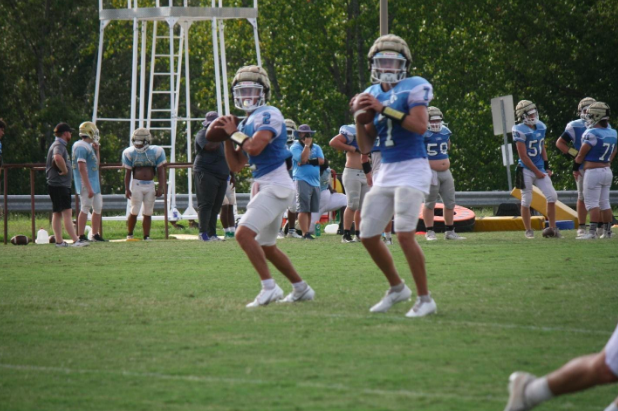 Daniel senior quarterbacks Jackson Crosby, left, and Wise Segars prepare to throw during practice on Sept. 10.