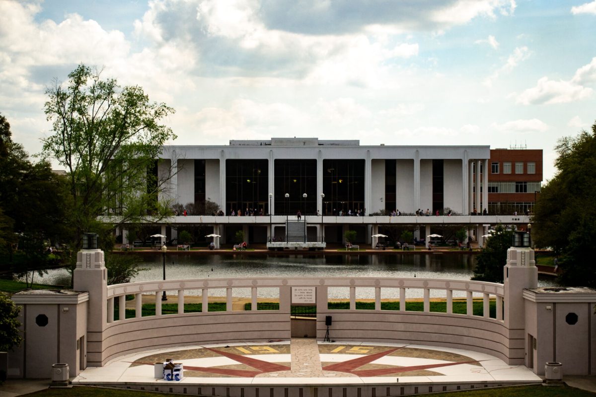 Cooper Library with students walking down Library Bridge, prior to the COVID-19 pandemic.