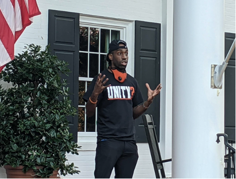 Russell Dinkins, a former Princeton track and field athlete and activist for track and field programs nationwide, speaks to the crowd in front of President Clements’ house.