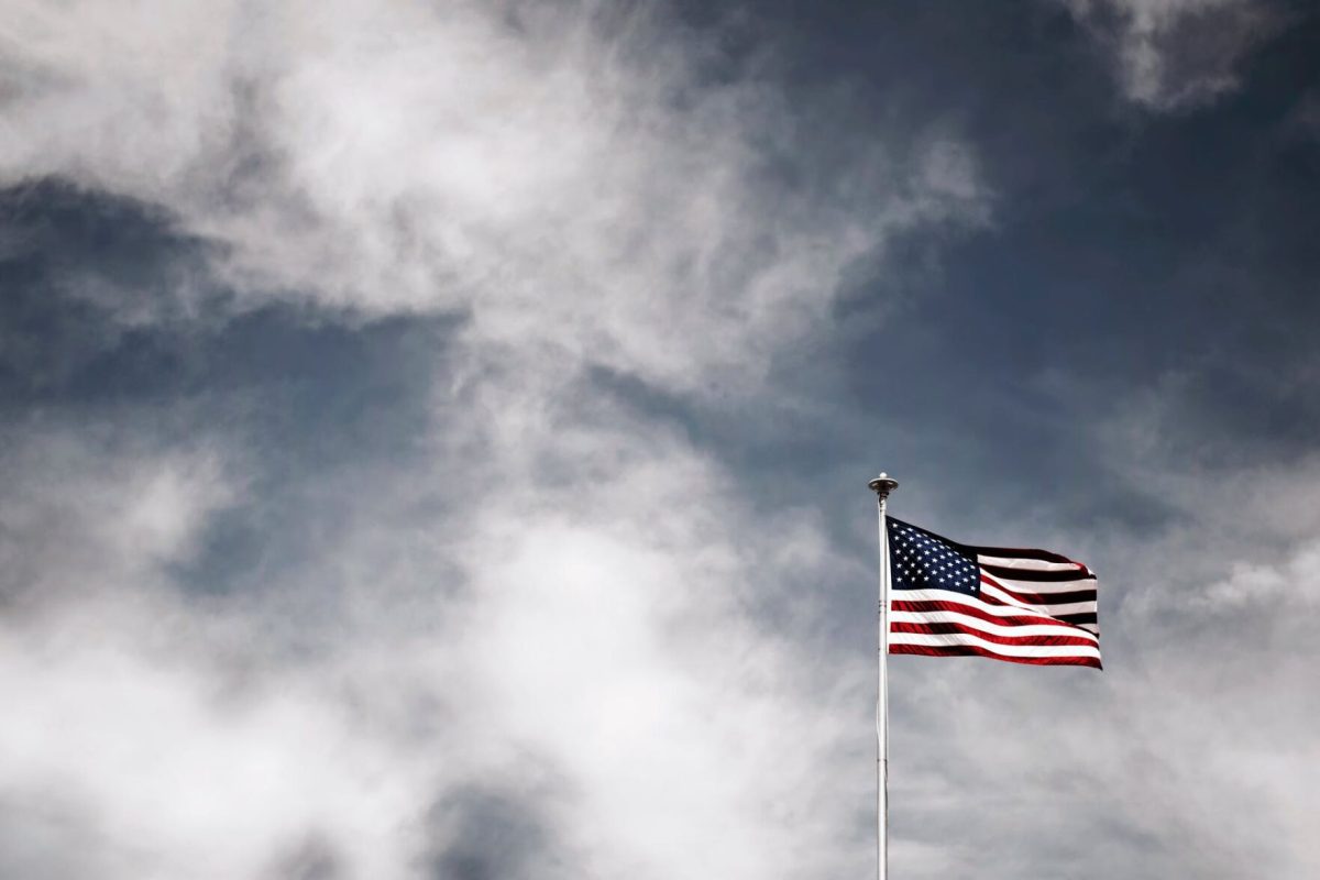 The American flag stands alone against a dark sky.&#160;