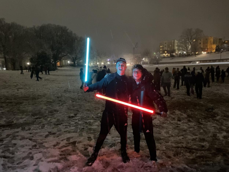Blom, left, posing with a lightsaber in hand after a duel with Burke, right.