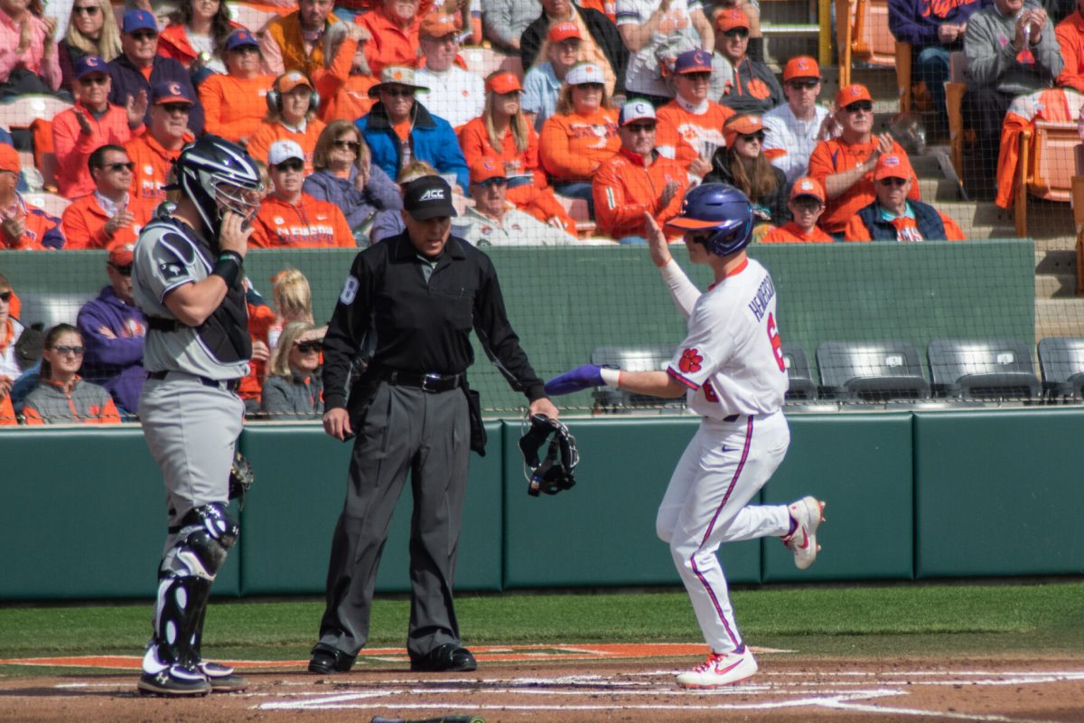 Outfielder Elijah Henderson scores a run in the first inning of the rubber match of the 2020 Palmetto Series at Doug Kingsmore Stadium in Clemson, S.C.