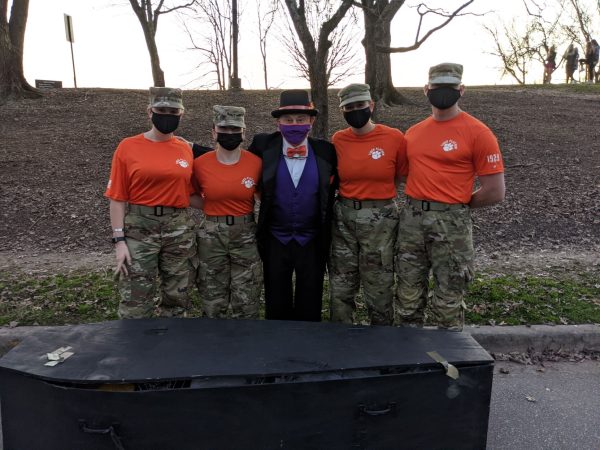 Colonel Sandy Edge and members of ROTC stand in front of Cocky's casket before the funeral procession.