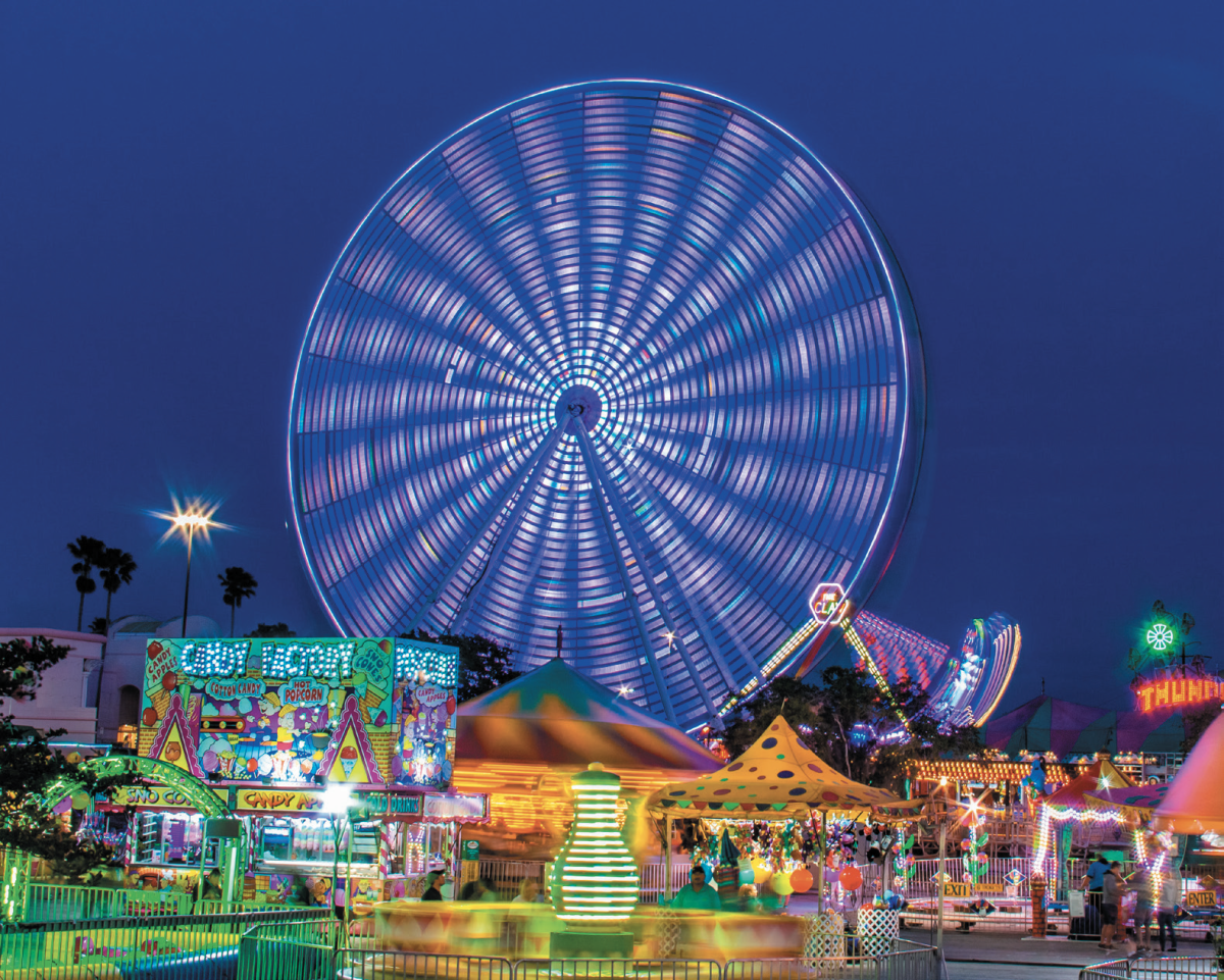 Theme park at night with ferris wheel