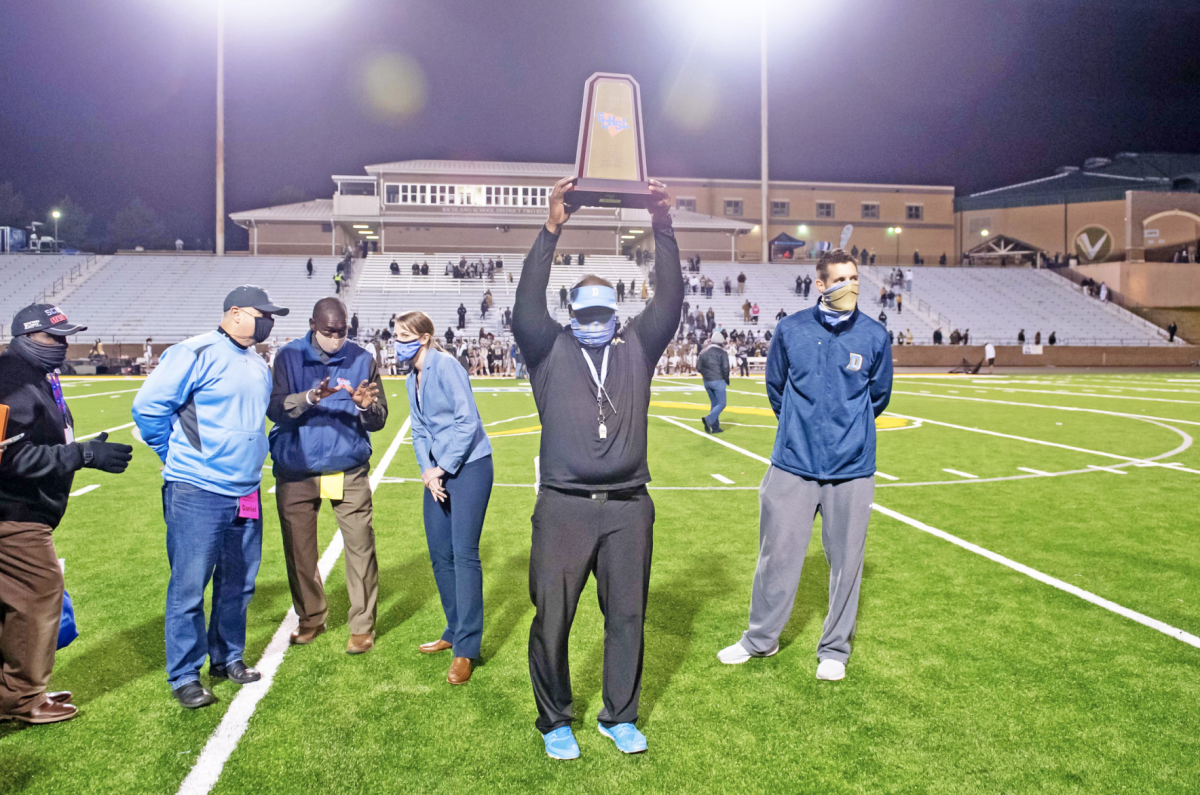 Daniel coach Jeff Fruster celebrates after winning the 2020 AAA Football State Championship