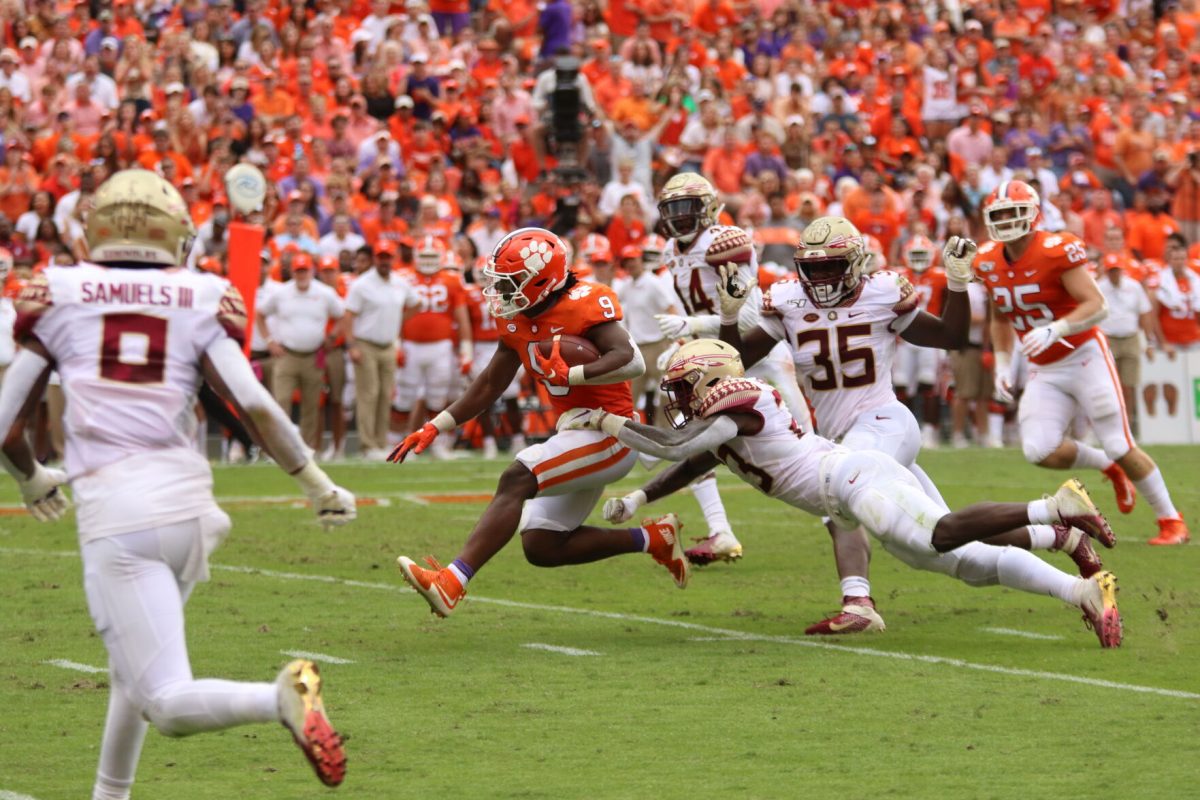 Travis Etienne (9) breaking a tackle against Florida State in Memorial Stadium