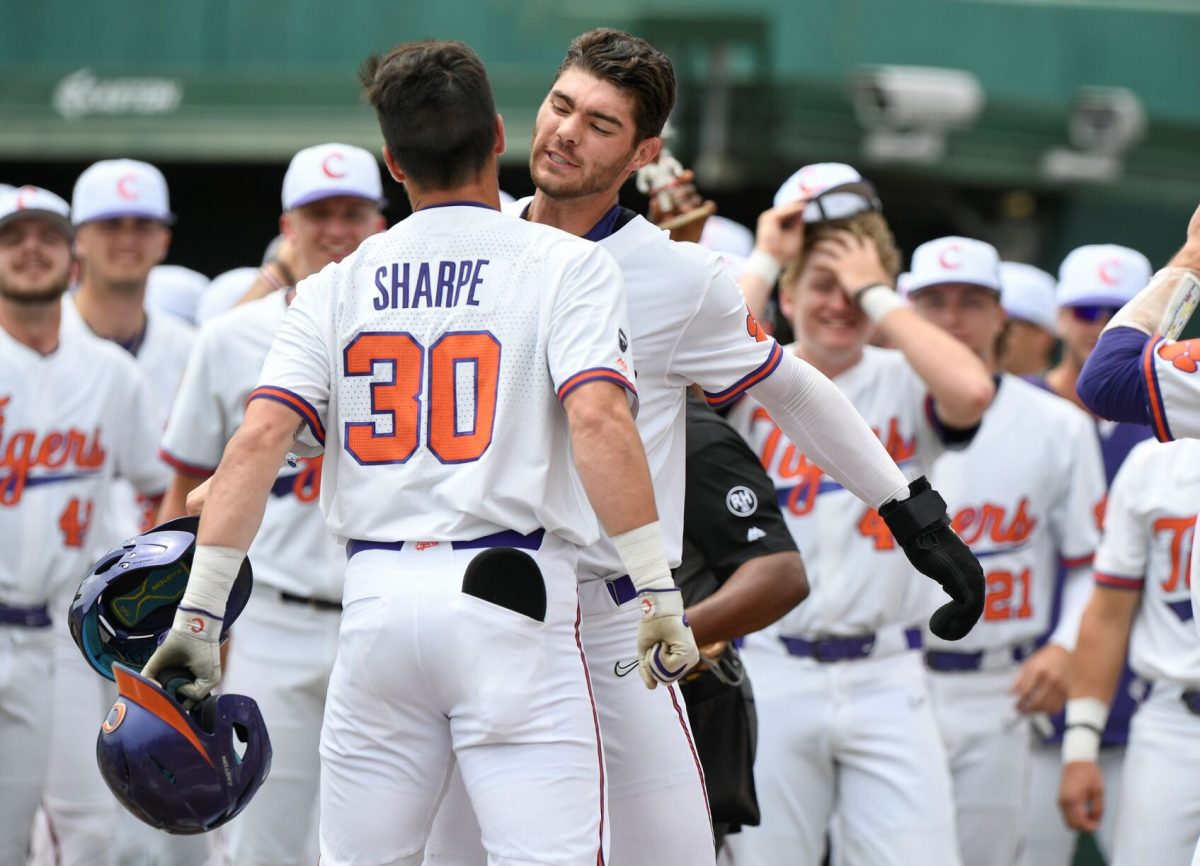 Davis Sharpe (30) and Caden Grice celebrate Sharpe's first inning home run against the Louisville Cardinals on Sunday, May 2 at Doug Kingsmore Stadium in Clemson, South Carolina.