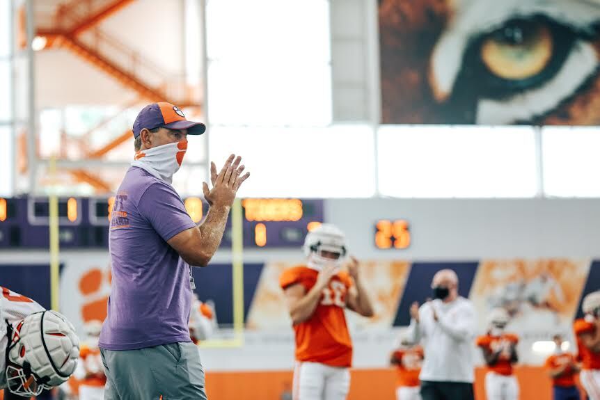 Head Coach Dabo Swinney wears his mask while watching players complete a drill during&#160;fall camp.