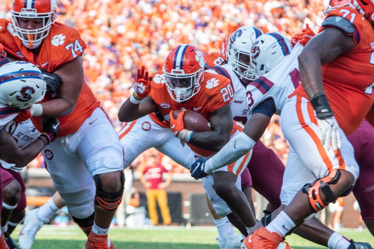 Sophomore running back Kobe Pace (20) drags two defenders across the goal line as he scores his first touchdown of the 2021 football season, Saturday, Sept. 11, 2021 at Clemson Memorial Stadium against the South Carolina State Bulldogs.