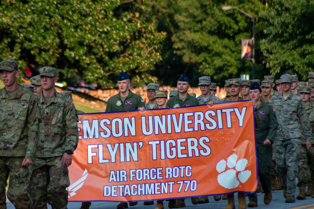 The Clemson University Flying Tigers march during the First Friday Parade in full fatigues, honoring the university's history as a military school.