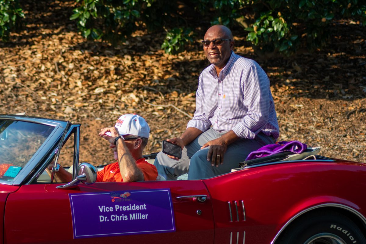 Dr. Chris Miller, vice president of Student Affairs, smiled and cheered with the fans watching the parade.