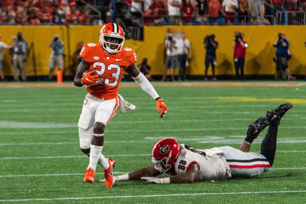 Clemson running back Lyn-J Dixon (23) avoids a tackle against Georgia on Sept. 4, 2021.