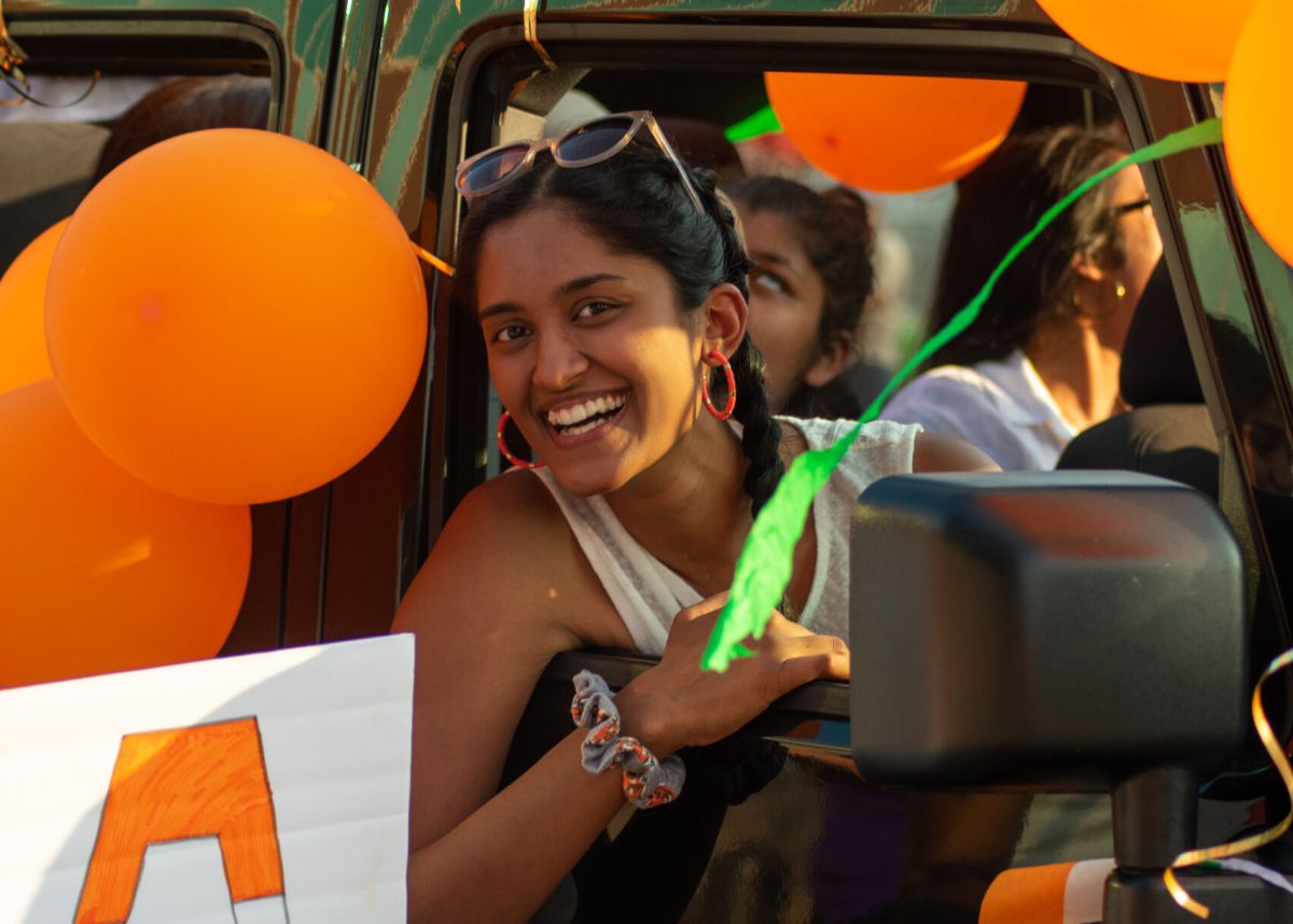 Shreya Thammana, junior copy editor for The Tiger, leans out of the car for the Indian Cultural Association to make the shot.