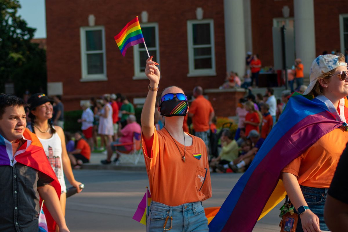 A member of PRISM at Clemson &#8212;&#160;a program for the LGBTQ+ community organized by the Peace Church &#8212; marches during the parade.