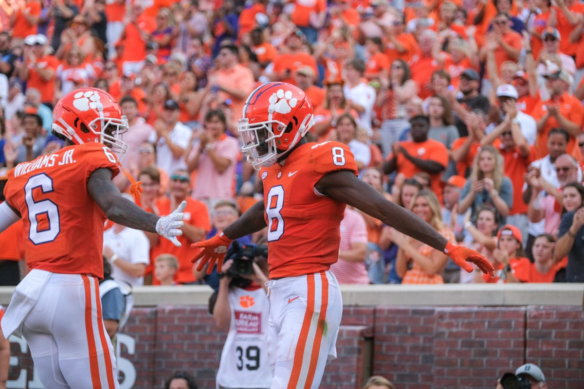 Justyn Ross (8) and E.J. Williams (6) celebrate against South Carolina State in Memorial Stadium on Sept. 11, 2021.