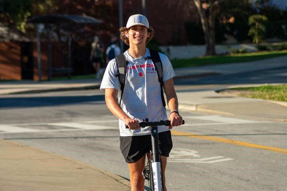 Carson Rourk, freshman student, enjoys using his scooter to get across campus.