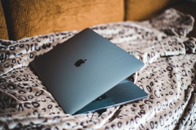 laptop resting on a bed