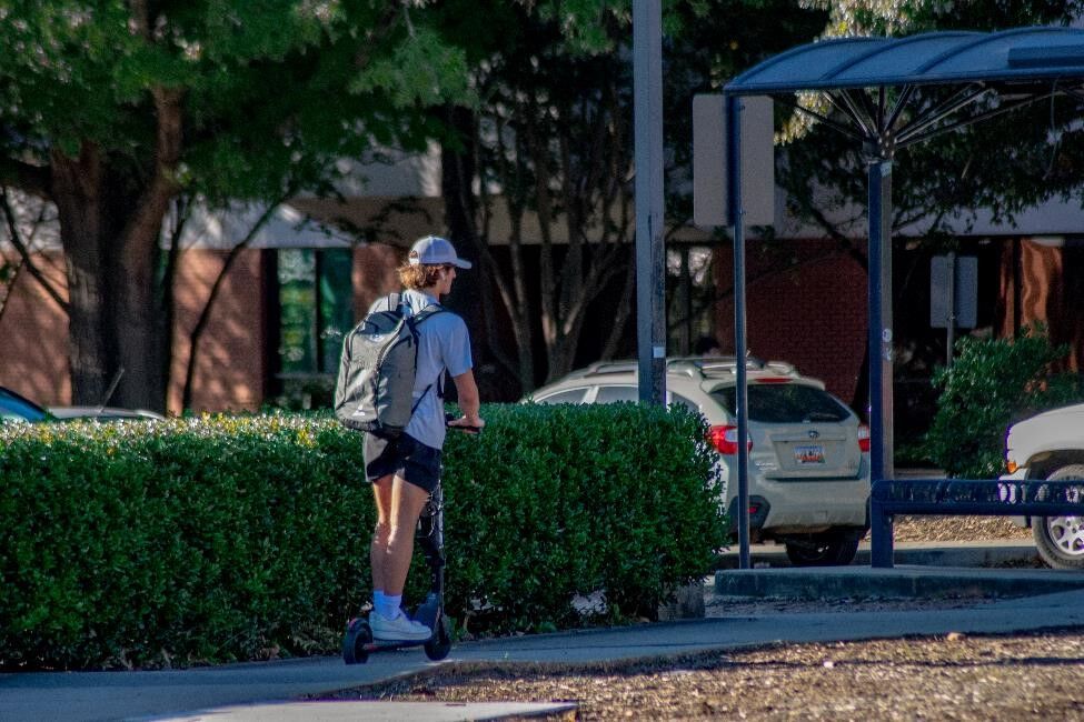 Carson Rourke scooters across campus.