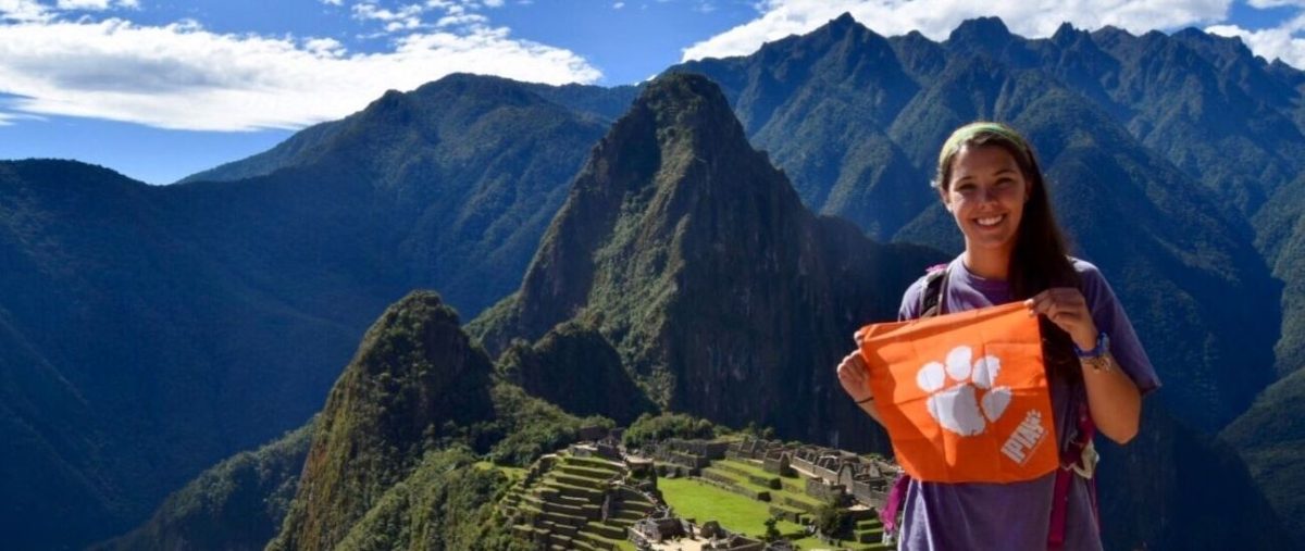 A Clemson student stands proudly in front of Machu Picchu in Peru on a study abroad trip.