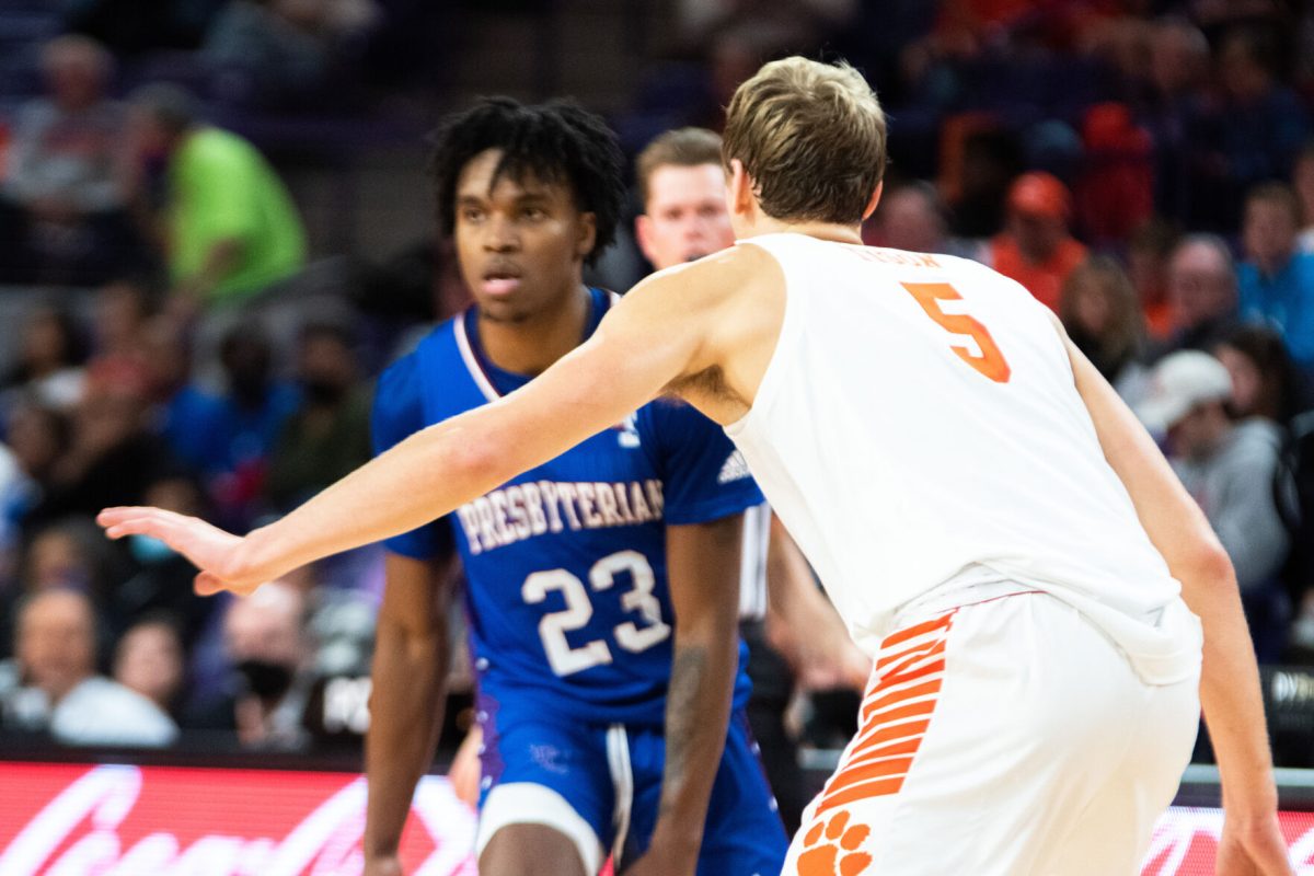 Clemson senior forward Hunter Tyson (5) guards Presbyterian guard&#160;Trevon Reddish-Rhone (23) during the second half of the teams' 2021 season opener at Littlejohn Coliseum in Clemson, S.C.