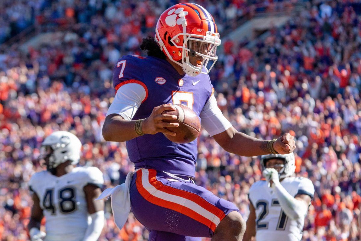 Clemson quarterback Taisun Phommachanh (7) scampers into the end zone vs. UConn in Memorial Stadium.