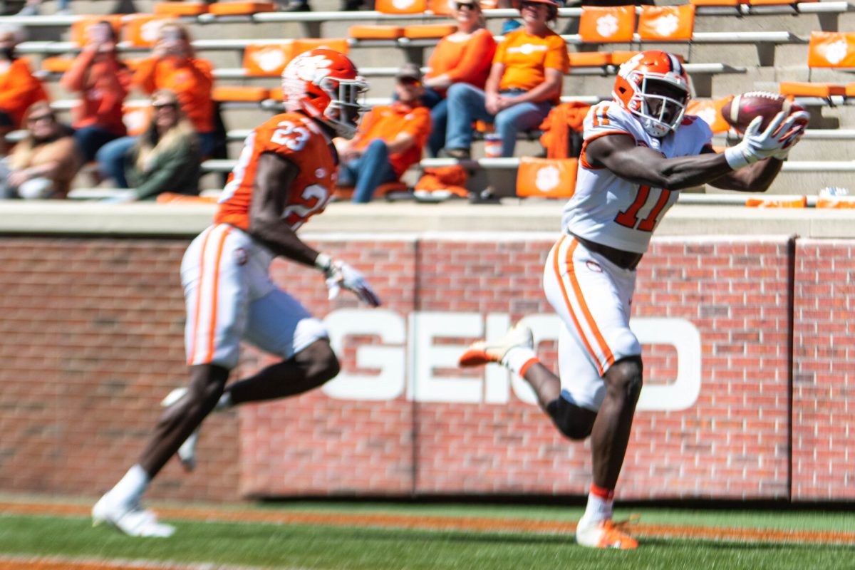 Wide receiver Ajou Ajou (11) catches the white team's first touchdown after separating from cornerback Andrew Booth Jr. (23) during the second half of the 2021 Clemson Orange-White Spring Game at Memorial Stadium in Clemson, S.C.