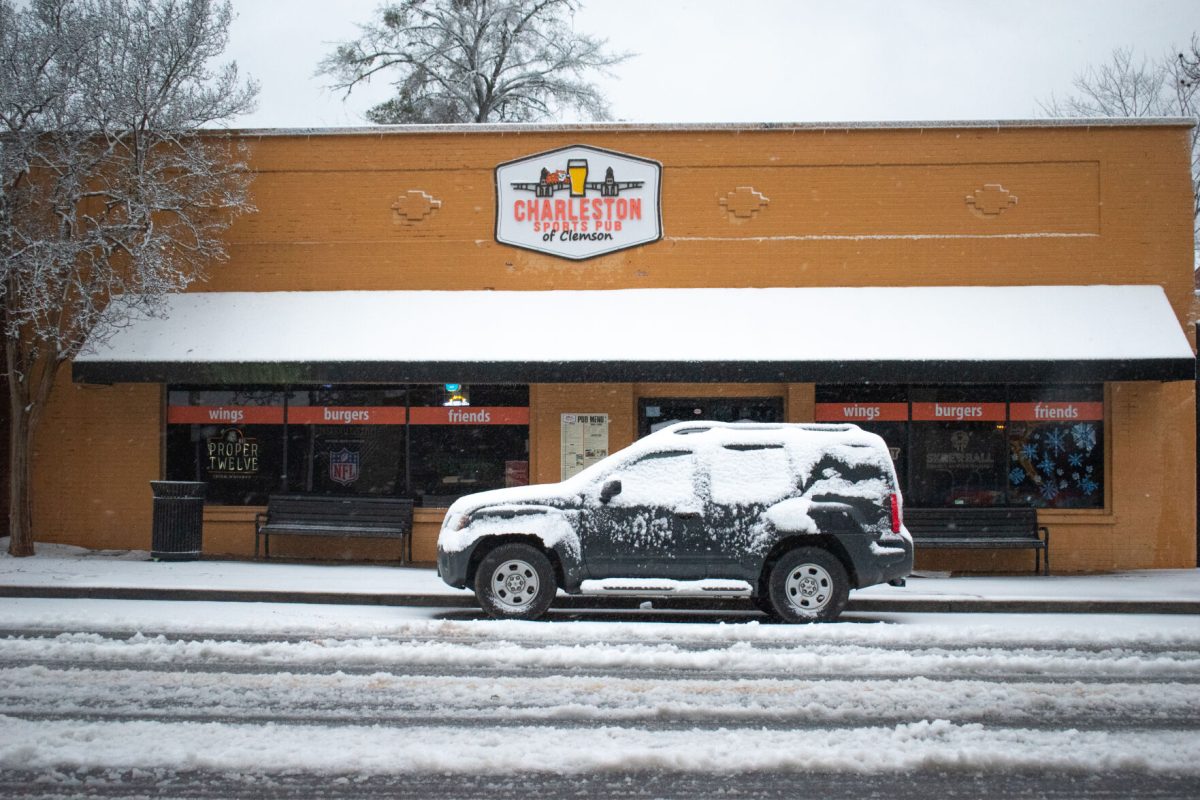 Charleston Sports Pub of Clemson sits with a car in front during the snow storm of Jan. 16, 2022.