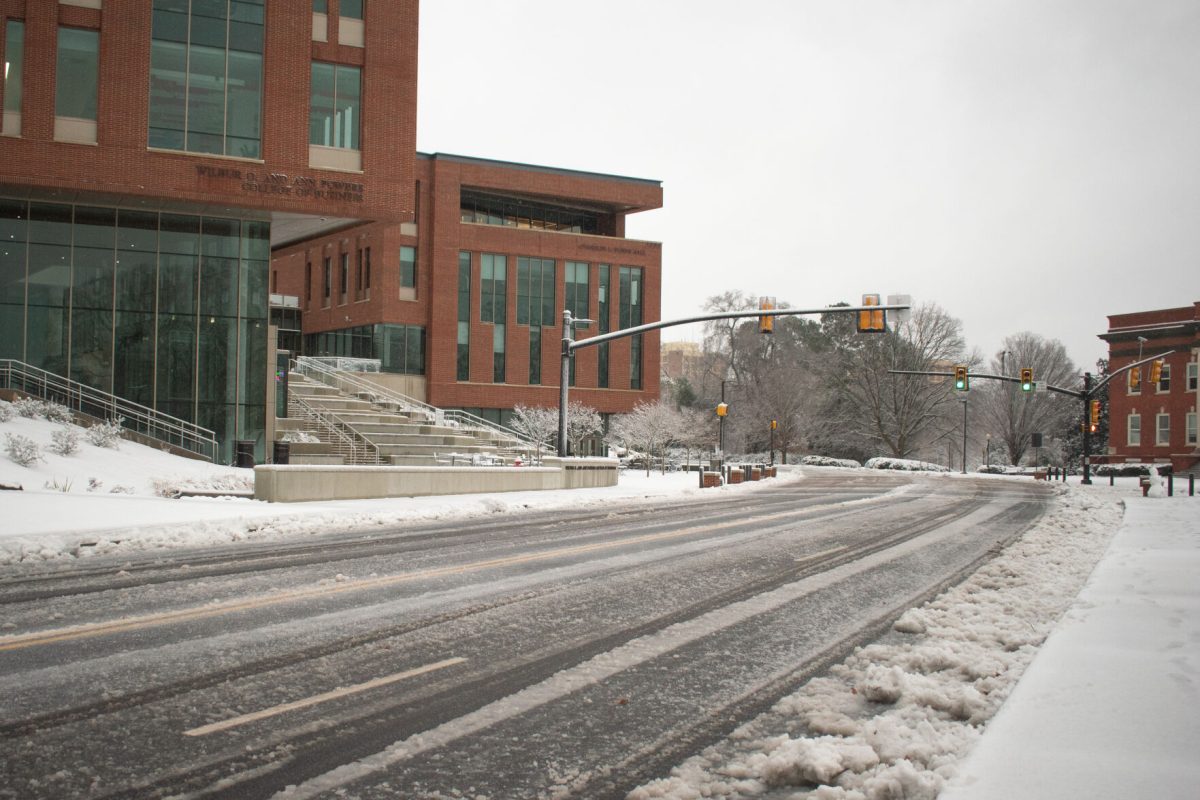 The College of Business building and adjacent intersection sits covered in snow early in the morning of Jan. 16, 2022.