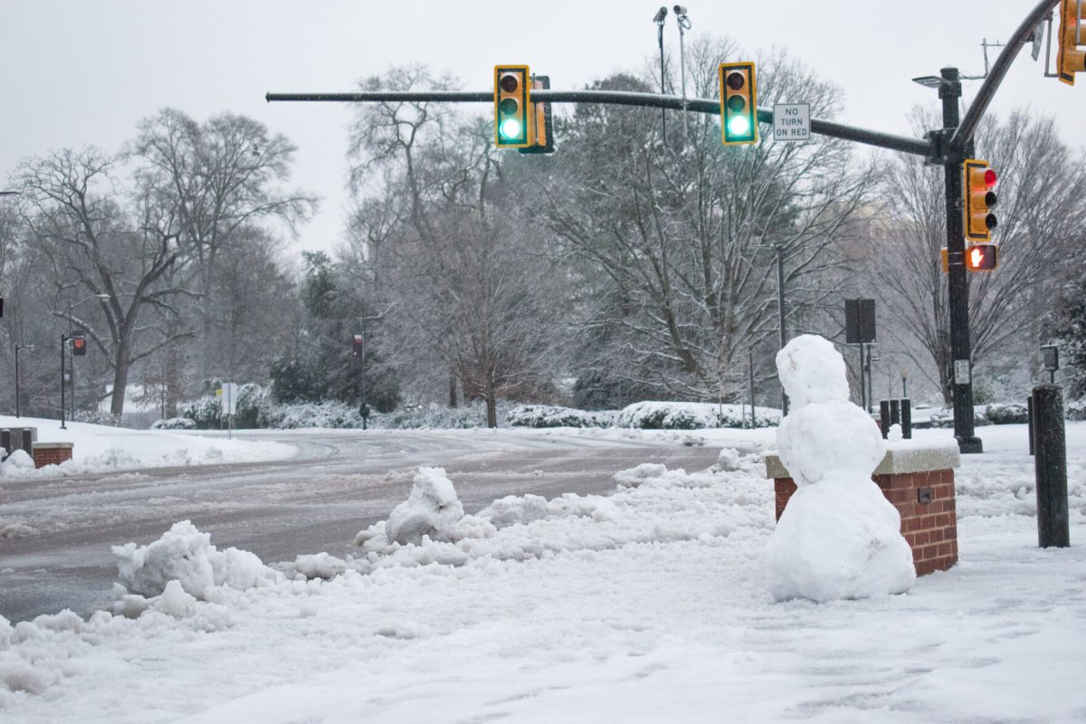 A lone snowperson awaits the crossing signal at the Sikes-Business College intersection early on the morning of Jan. 16, 2022.