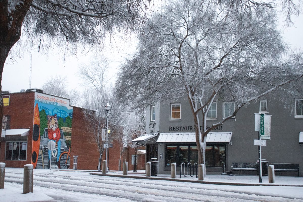 Study Hall, right, and Judge Kellers Store, left, sit along a snow-and-ice-covered College Avenue in downtown Clemson early in the morning on Jan. 16, 2022.