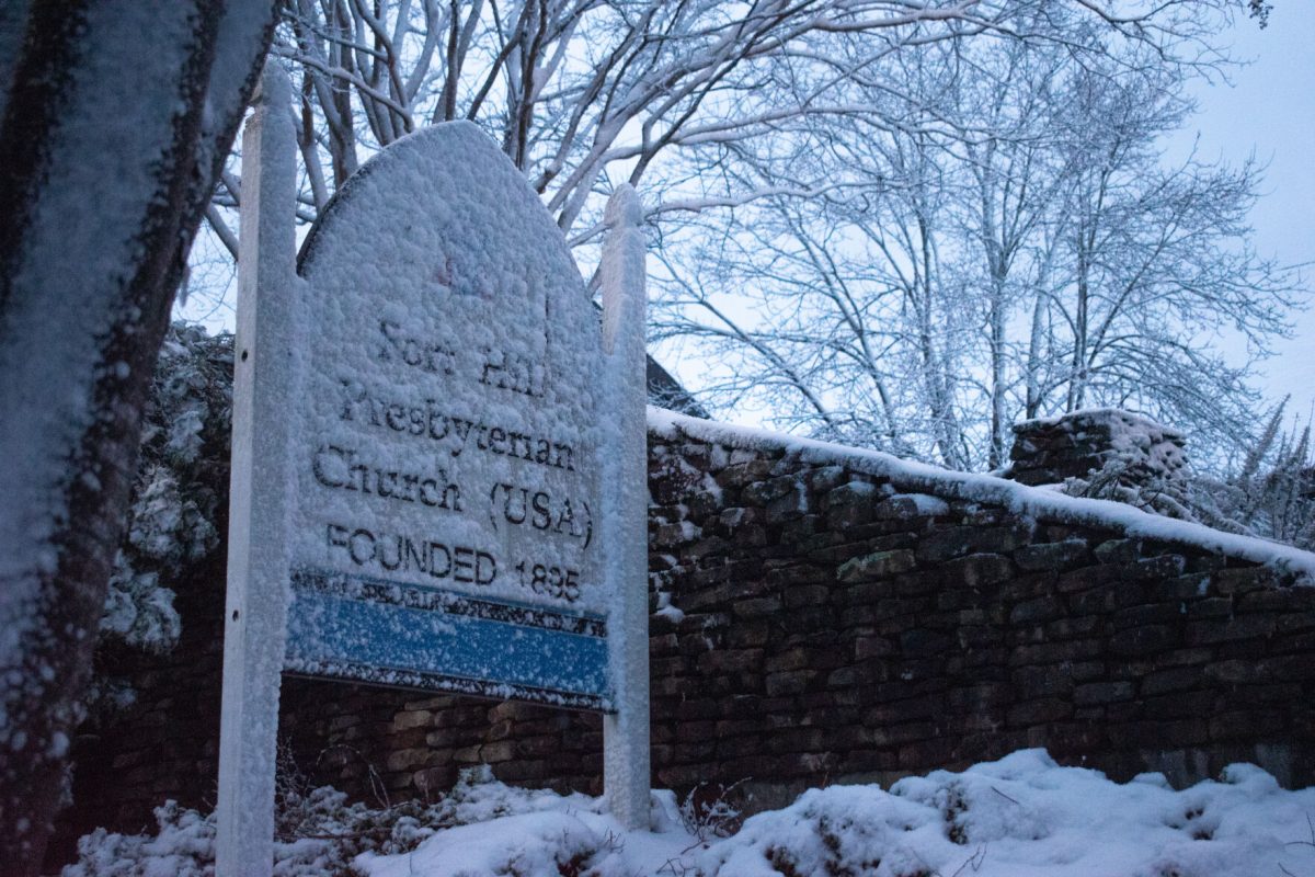 The sign for Fort Hill Presbyterian Church is covered in snow early on the morning of Jan. 16, 2022.