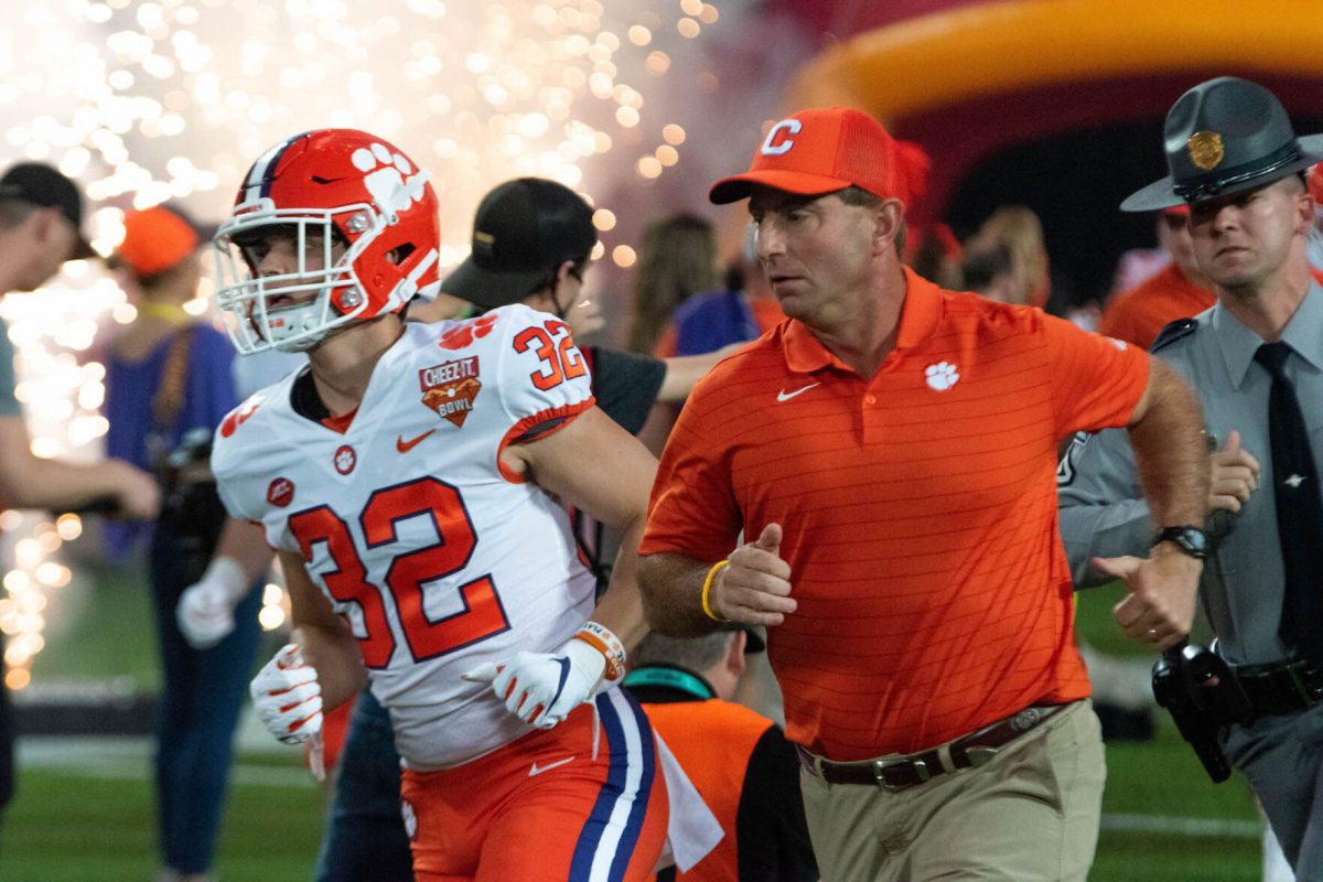 Clemson+head+coach+Dabo+Swinney+leads+his+team+out+of+the+tunnel+in+the+2021+Cheez-It+Bowl.+Clemson+went+on+to+defeat+Iowa+State+in+the+game%2C+securing+the+teams+tenth+win+on+the+season.